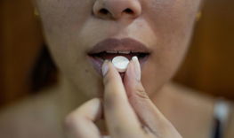 woman putting her hand on her lips